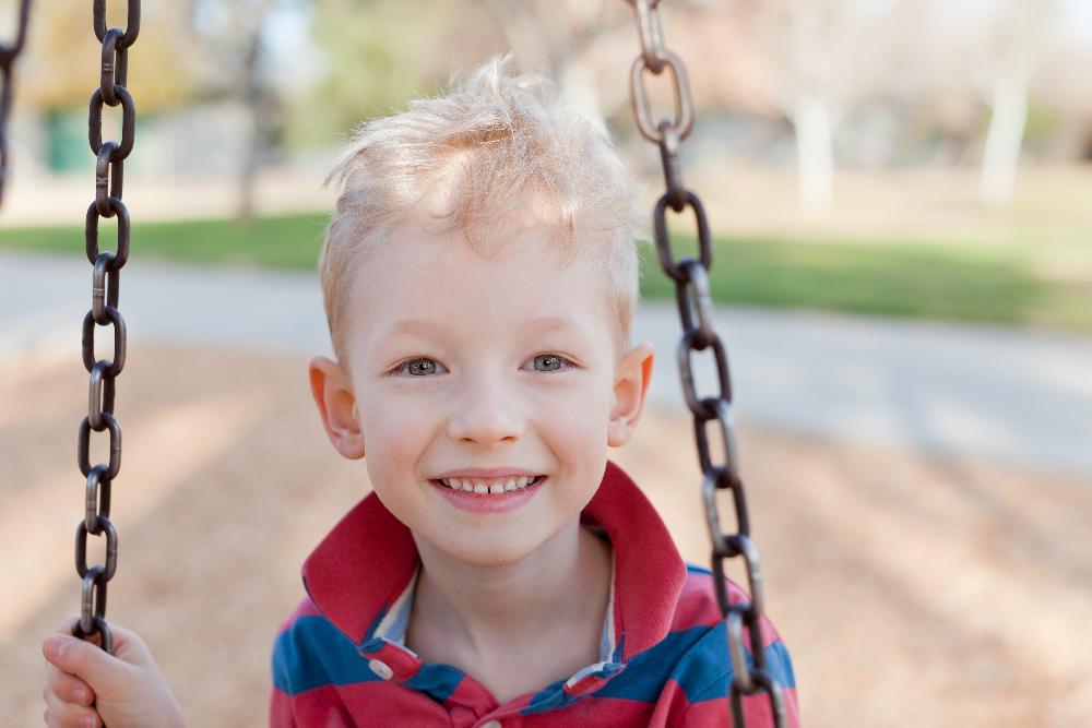 young boy on swing | dentist st paul mn