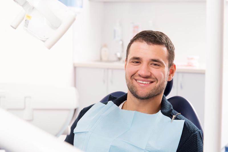 A Man Smiles In The Dental Chair | Pain-Free Dentistry St. Paul, MN