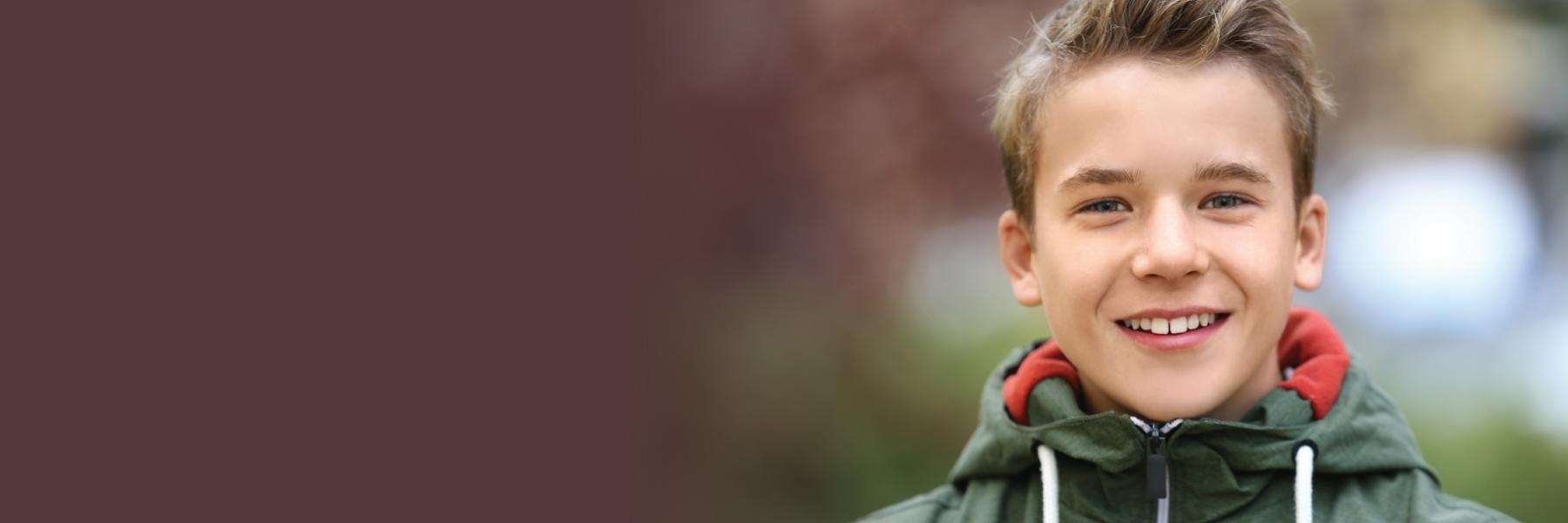 boy in green jacket smiling | dentist st paul mn