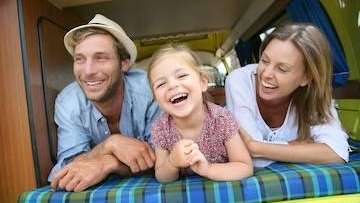 father, daughter, and mother laughing