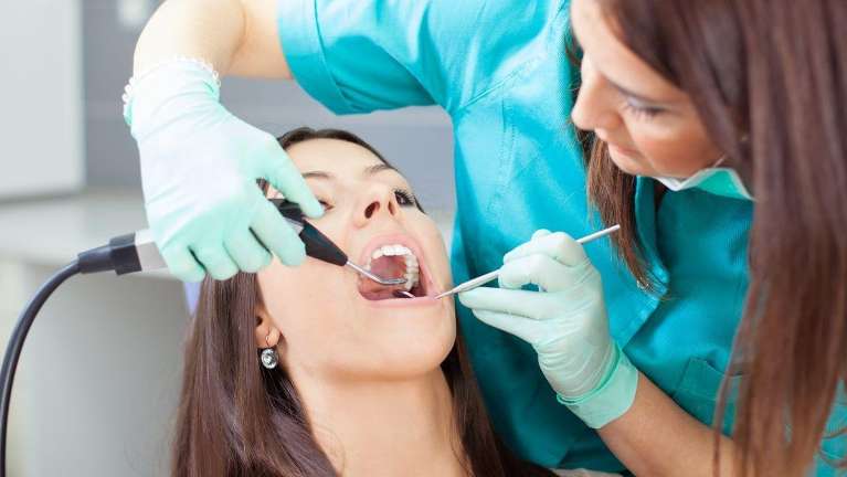 woman getting teeth cleaned in saint paul