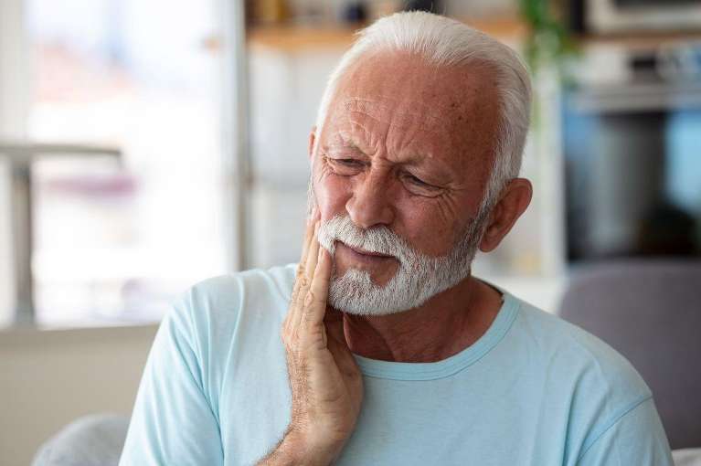 Older man holding his jaw in pain, saint-paul mn