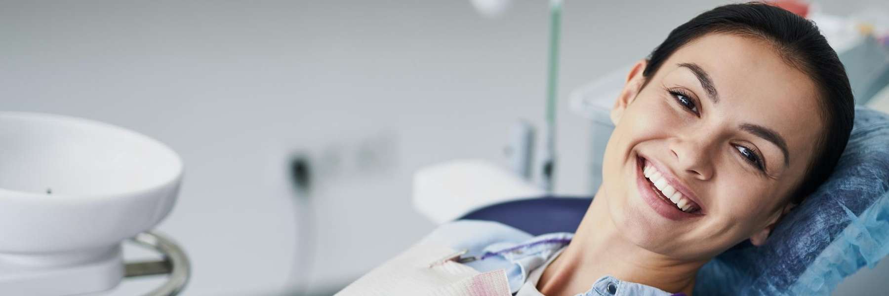 woman sitting in exam chair | dentist st paul mn