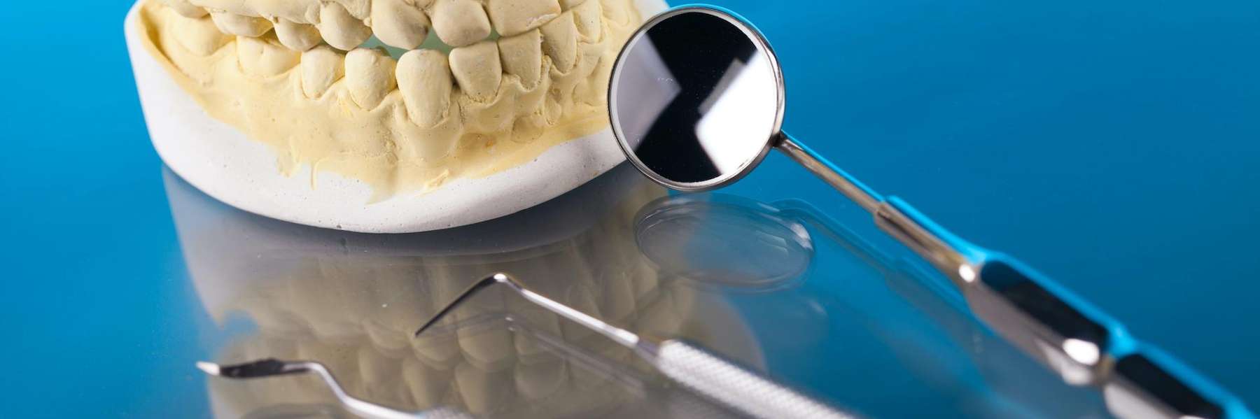 Dental tools laying next to a mold of a human mouth, st paul mn